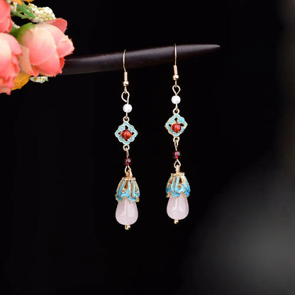 Pair of long red and turquoise earrings with gold-tone hooks