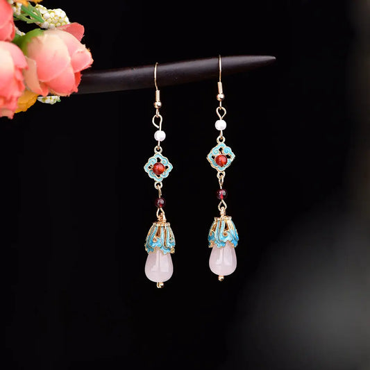 Pair of long red and turquoise earrings with gold-tone hooks