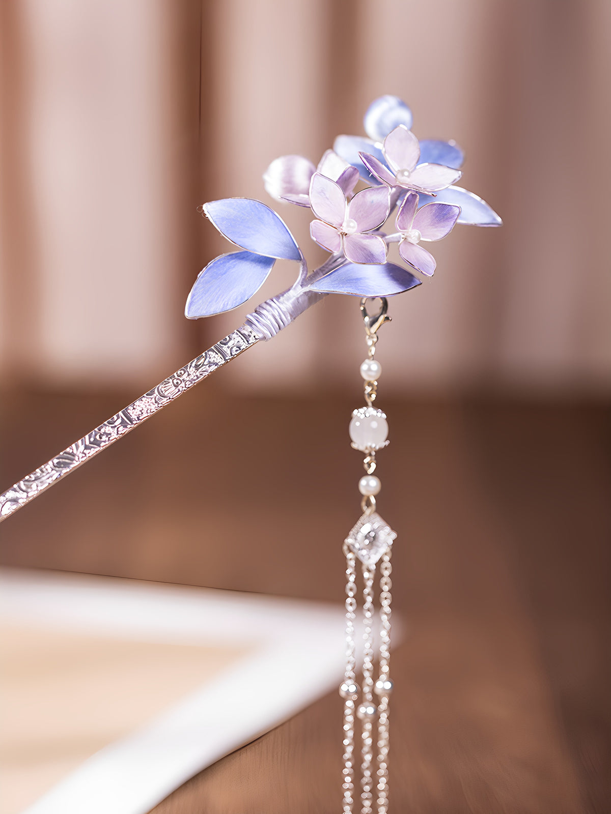 Purple floral hairpin shown on a light background