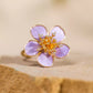 Close-up of the purple five-petal flower and gold-tone alloy band