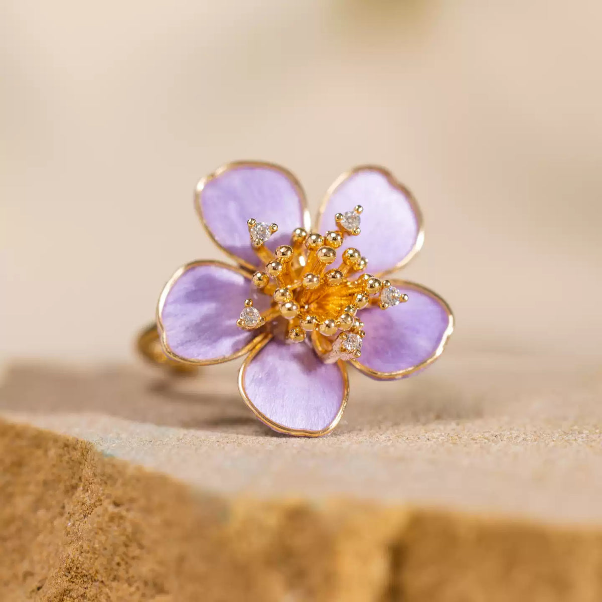 Close-up of the purple five-petal flower and gold-tone alloy band