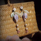 Lily of the valley dangle earrings with pale leaves, lavender fabric flowers, and bead accents