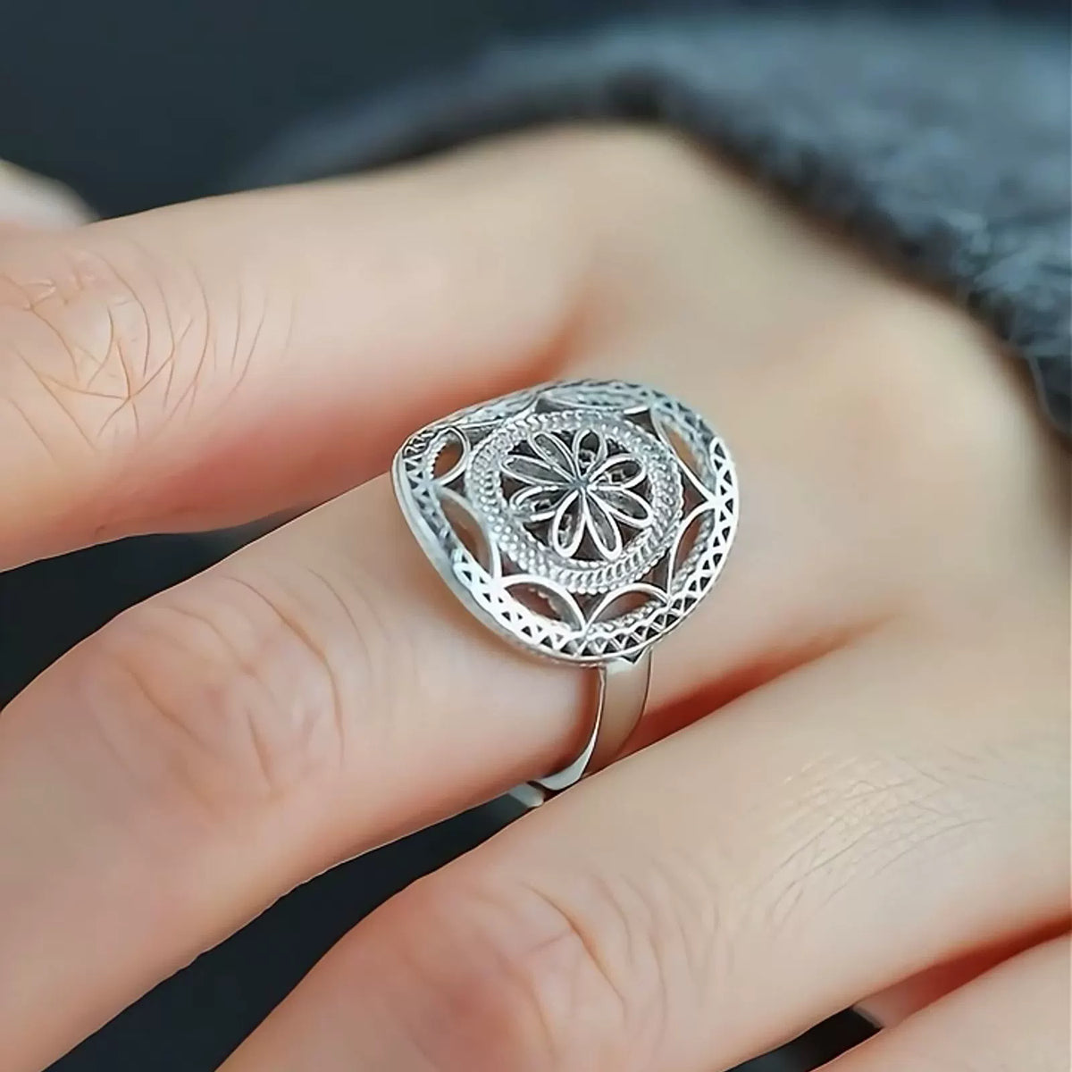 Close-up of the adjustable open band and raised floral ring face