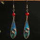 Hanging view of the bamboo leaf teardrop earrings with gold-tone wire details
