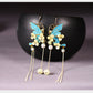 Blue butterfly and floral tassel earrings, front view