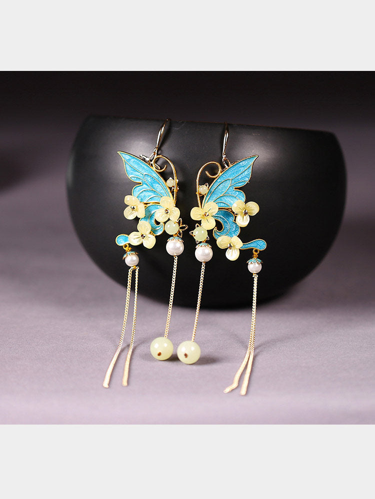 Blue butterfly and floral tassel earrings, front view