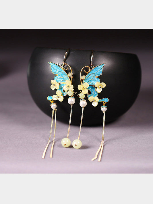 Blue butterfly and floral tassel earrings, front view