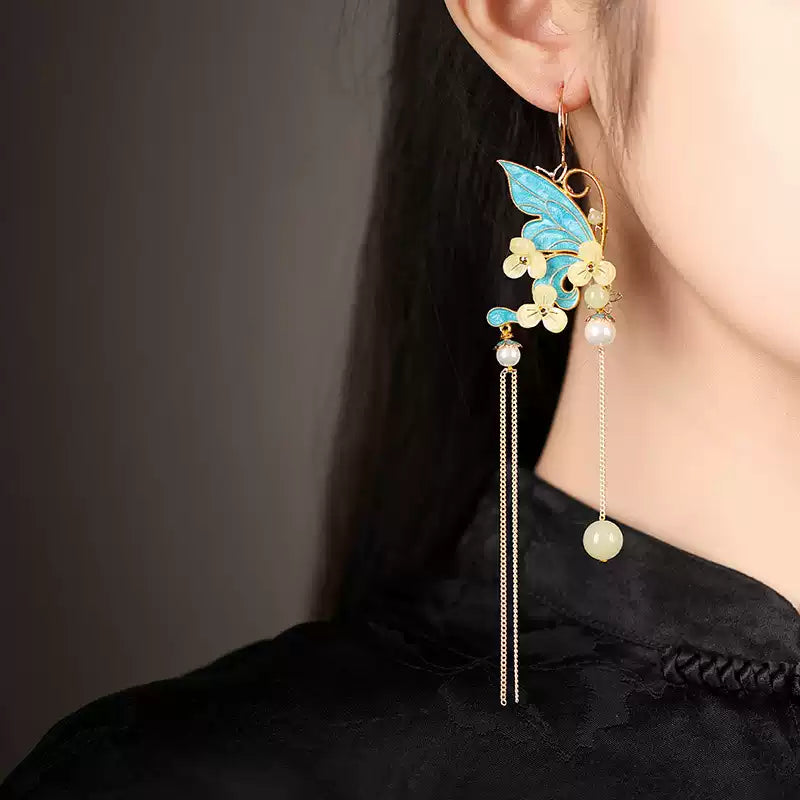 Long blue butterfly tassel earring worn, side view