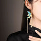 Model wearing a long butterfly tassel earring