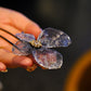 Hand-held close-up of the metal-mesh butterfly hairpin