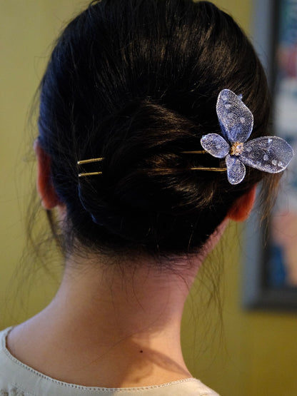 Blue metal-mesh butterfly U-shaped hairpin styled in a bun
