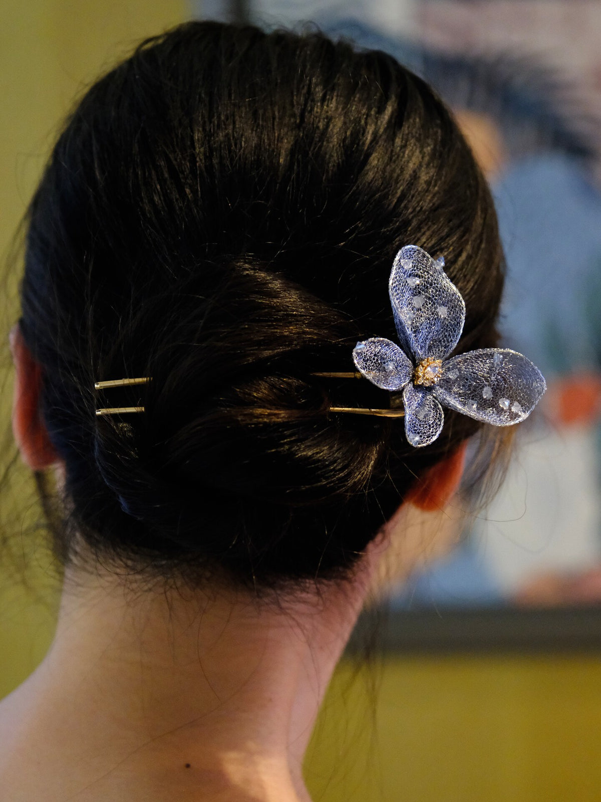 Close view of the blue butterfly hairpin in an updo