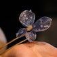 Blue butterfly hairpin worn in a low bun