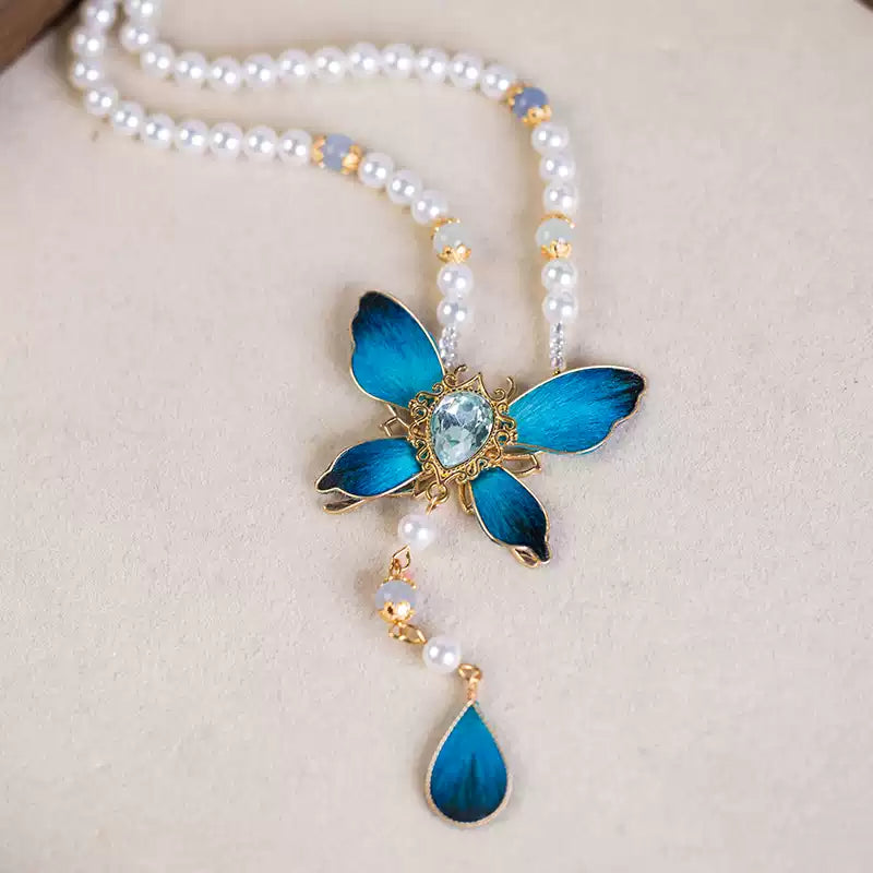 Close-up of the blue butterfly pendant and teardrop drop