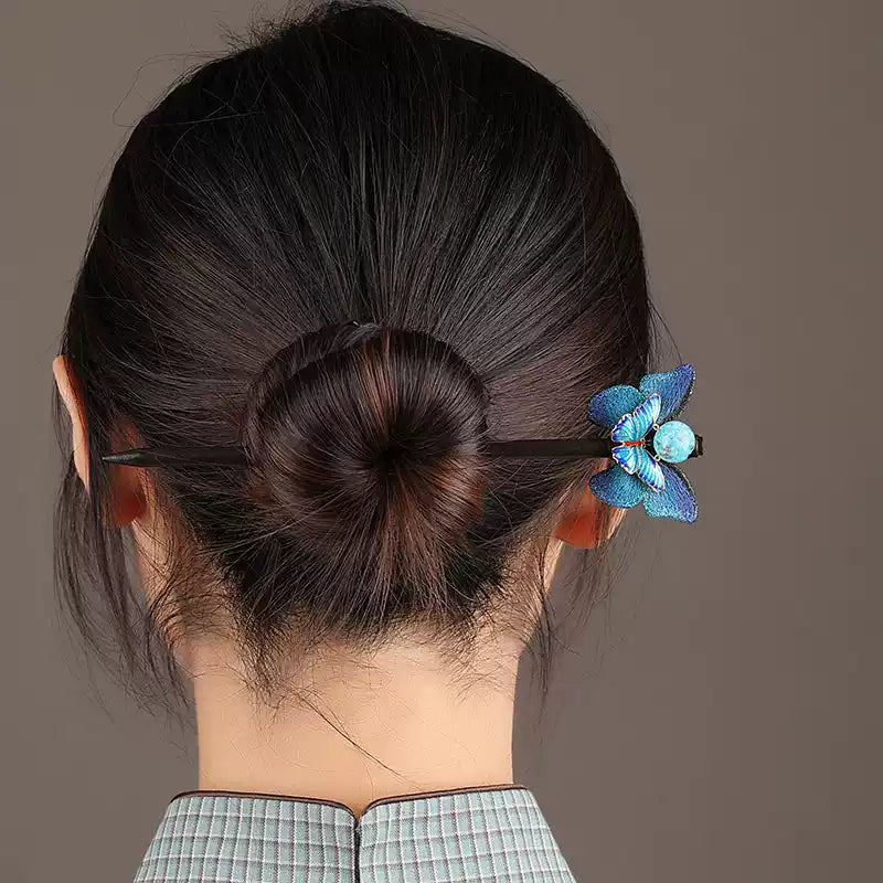 Blue butterfly hairpin styled in a bun