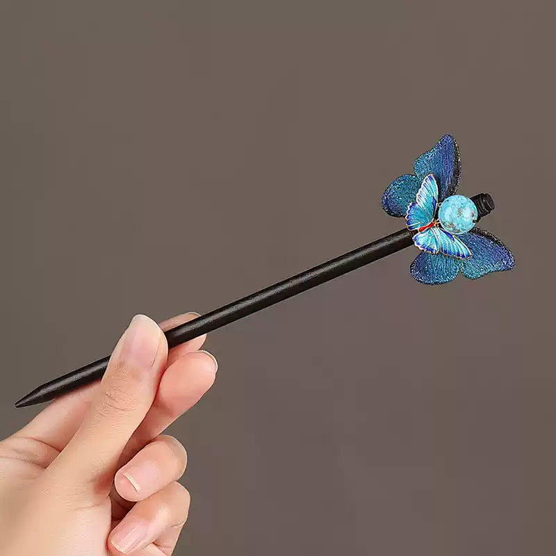 Hand-held view of the blue butterfly hair stick