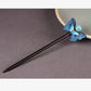 Full view of the dark wooden butterfly hairpin