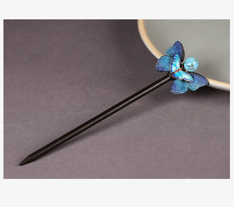 Full view of the dark wooden butterfly hairpin