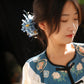 Blue chrysanthemum hairpin styled with a traditional-inspired outfit