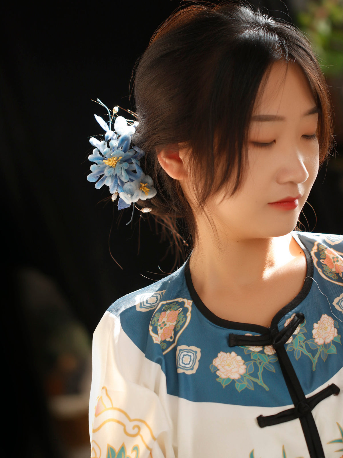 Blue chrysanthemum hairpin styled with a traditional-inspired outfit