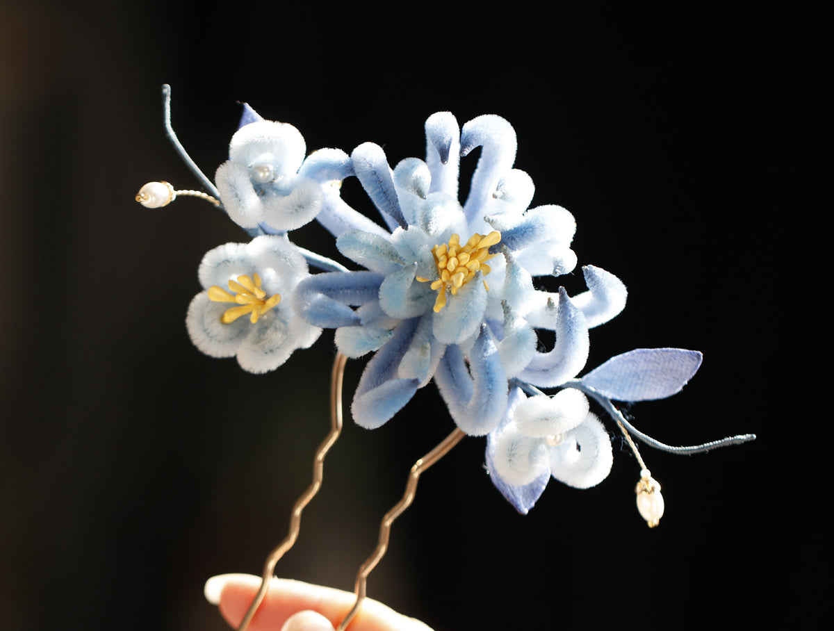 Blue chrysanthemum floral hair stick shown in detail