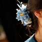 Side profile of the blue chrysanthemum hair ornament when worn