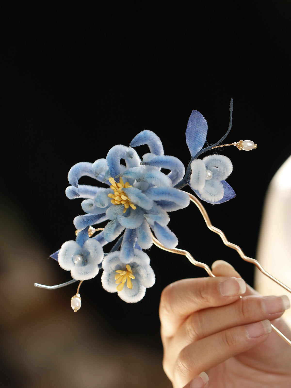 Close detail of the blue chrysanthemum flower and dangling accents