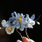 Blue chrysanthemum hair ornament worn in an updo