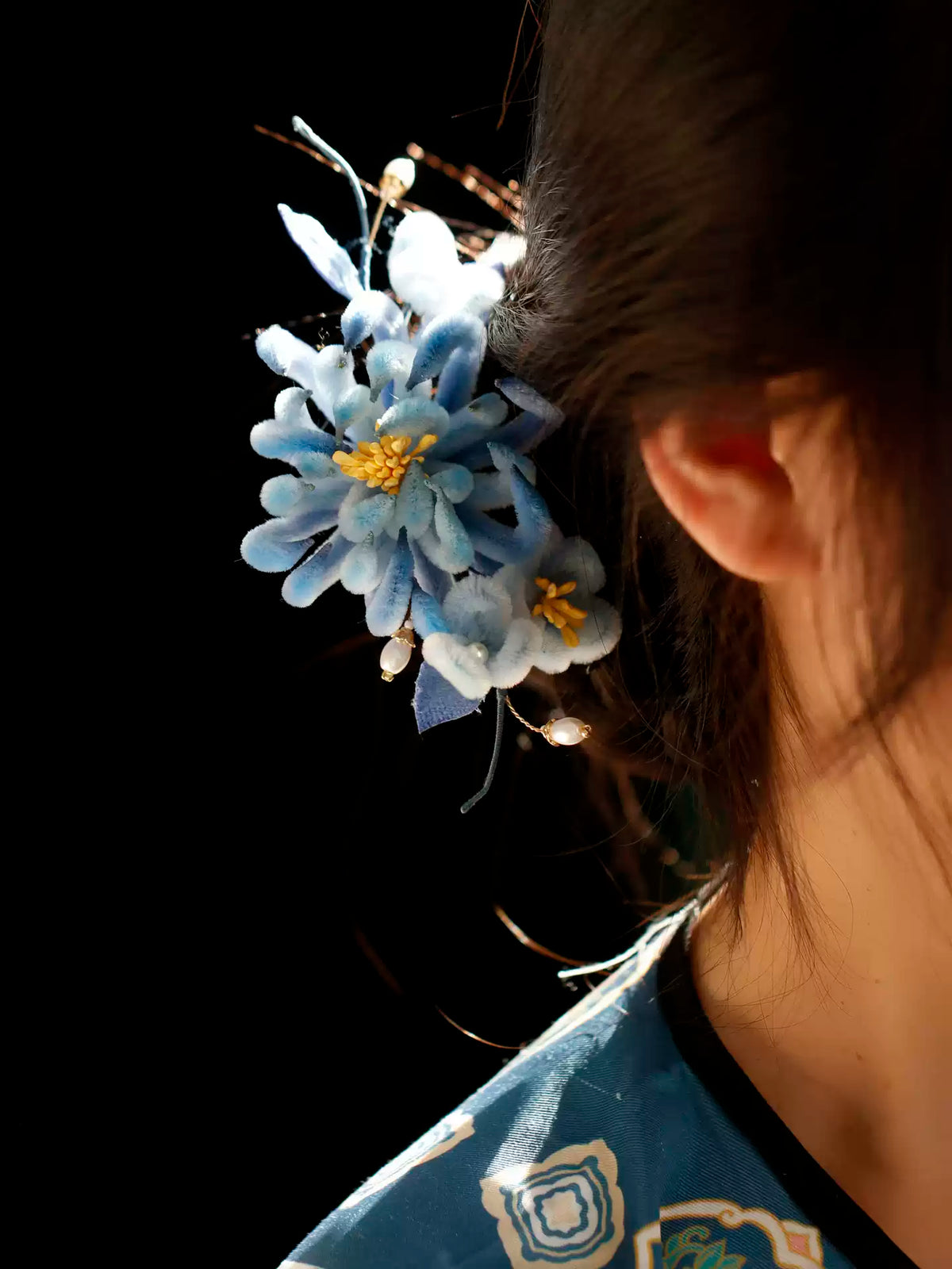 Close view of the blue chrysanthemum hairpin in an updo