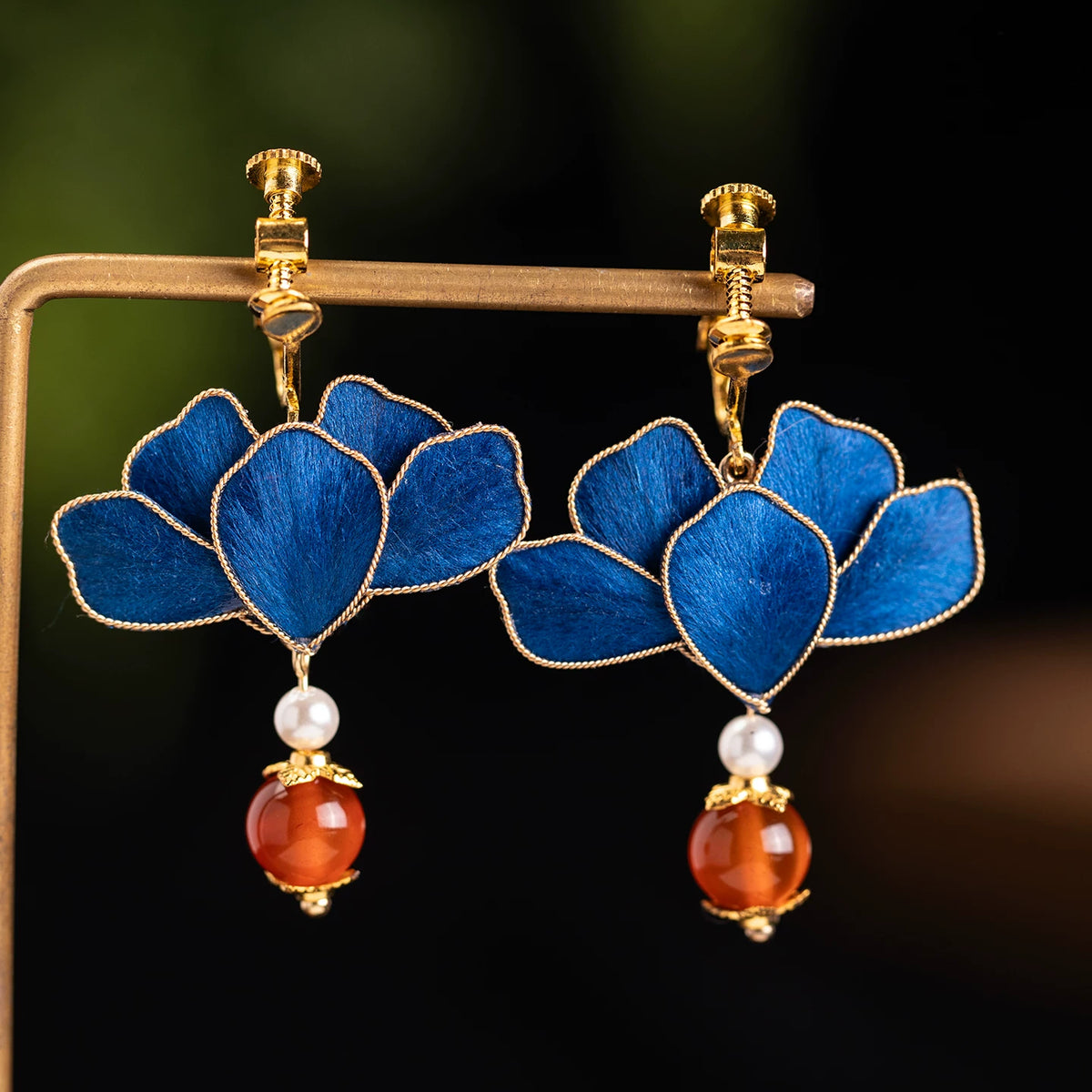 Pair of blue flower drop earrings with white and red-orange bead accents