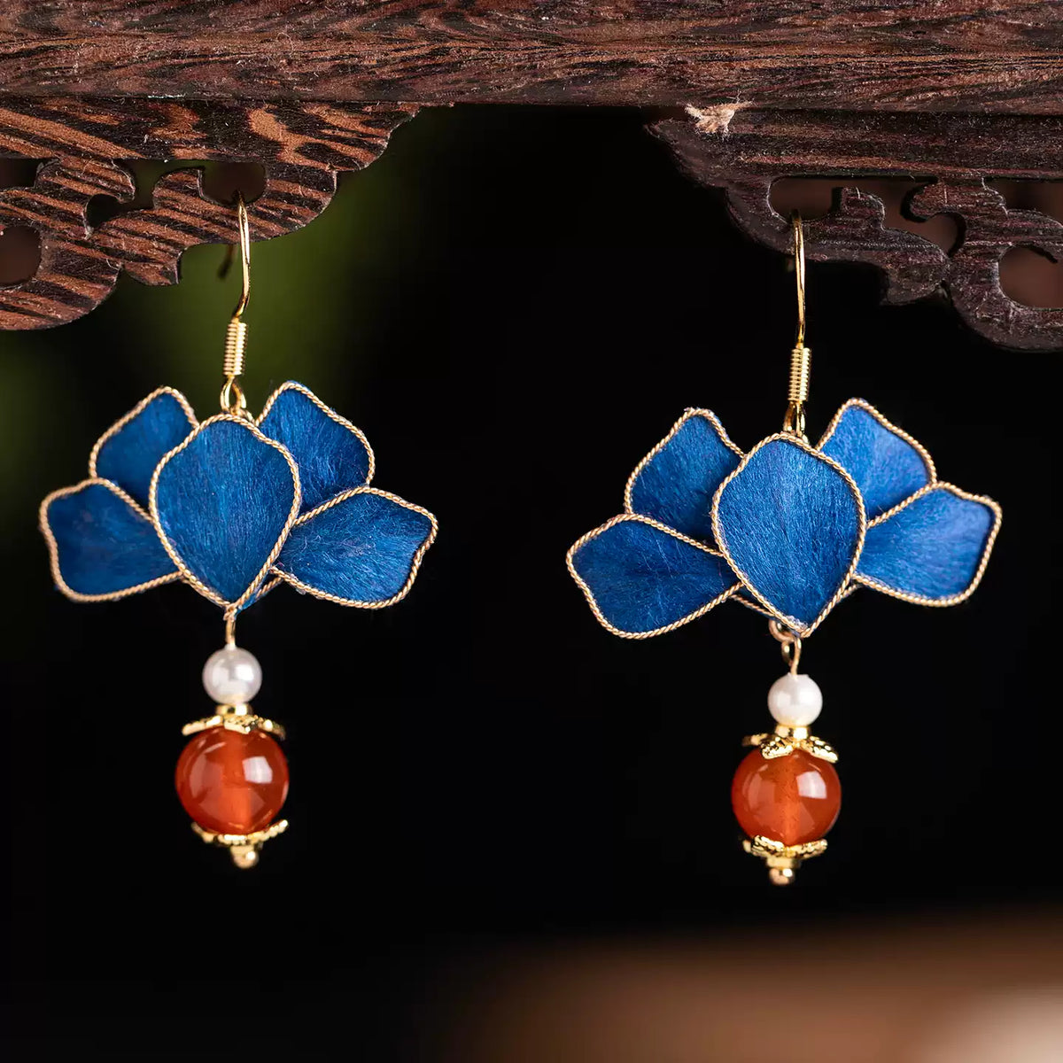 Close view of the blue petal design with gold-tone edging and bead drops
