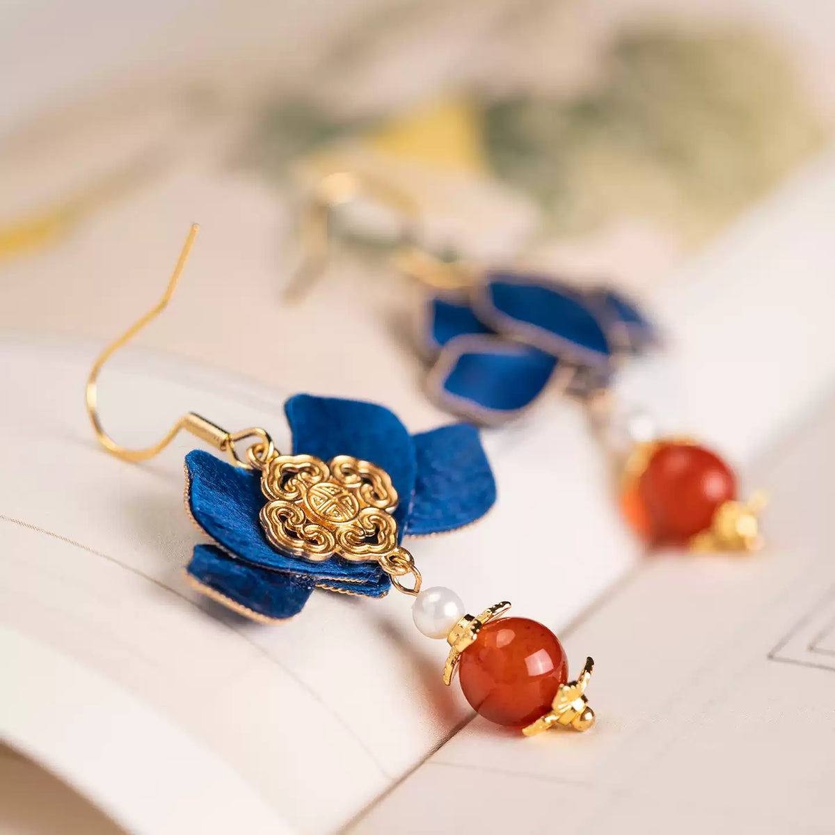 Angled view of the blue flower earrings and decorative reverse