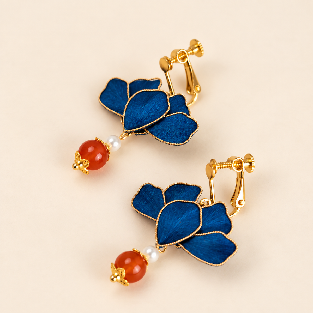Pair of blue flower earrings with visible clip-on hardware