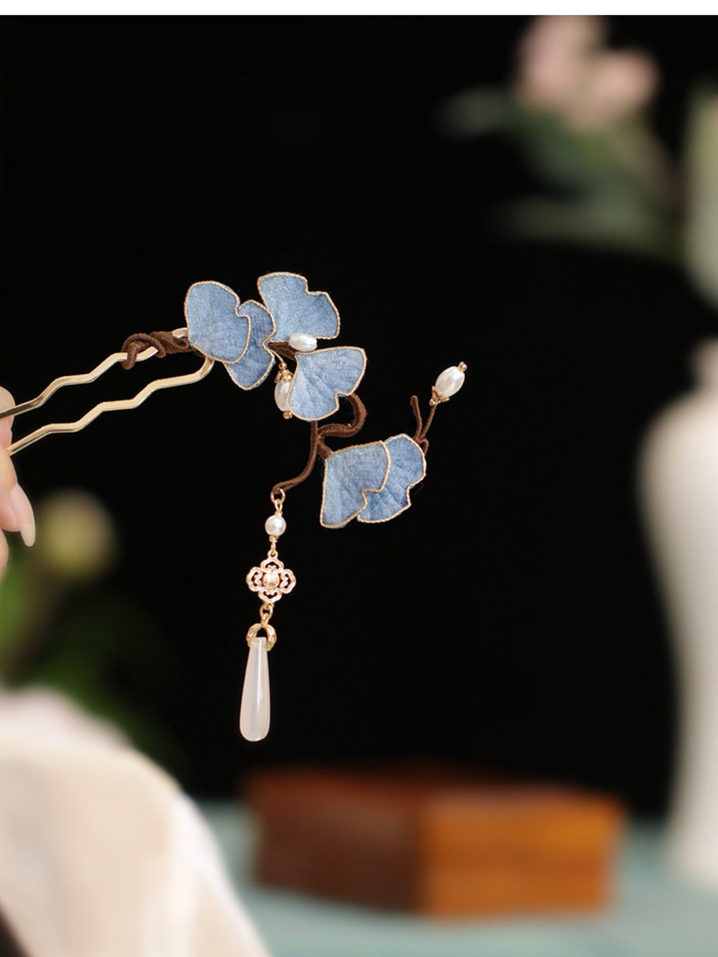 Close-up of blue fabric ginkgo leaf U hairpin with faux pearl and dangling tassel