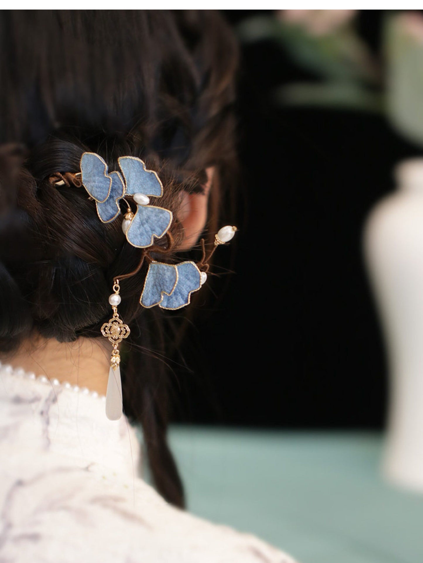 Blue ginkgo leaf hairpin worn in an updo with pearl tassel