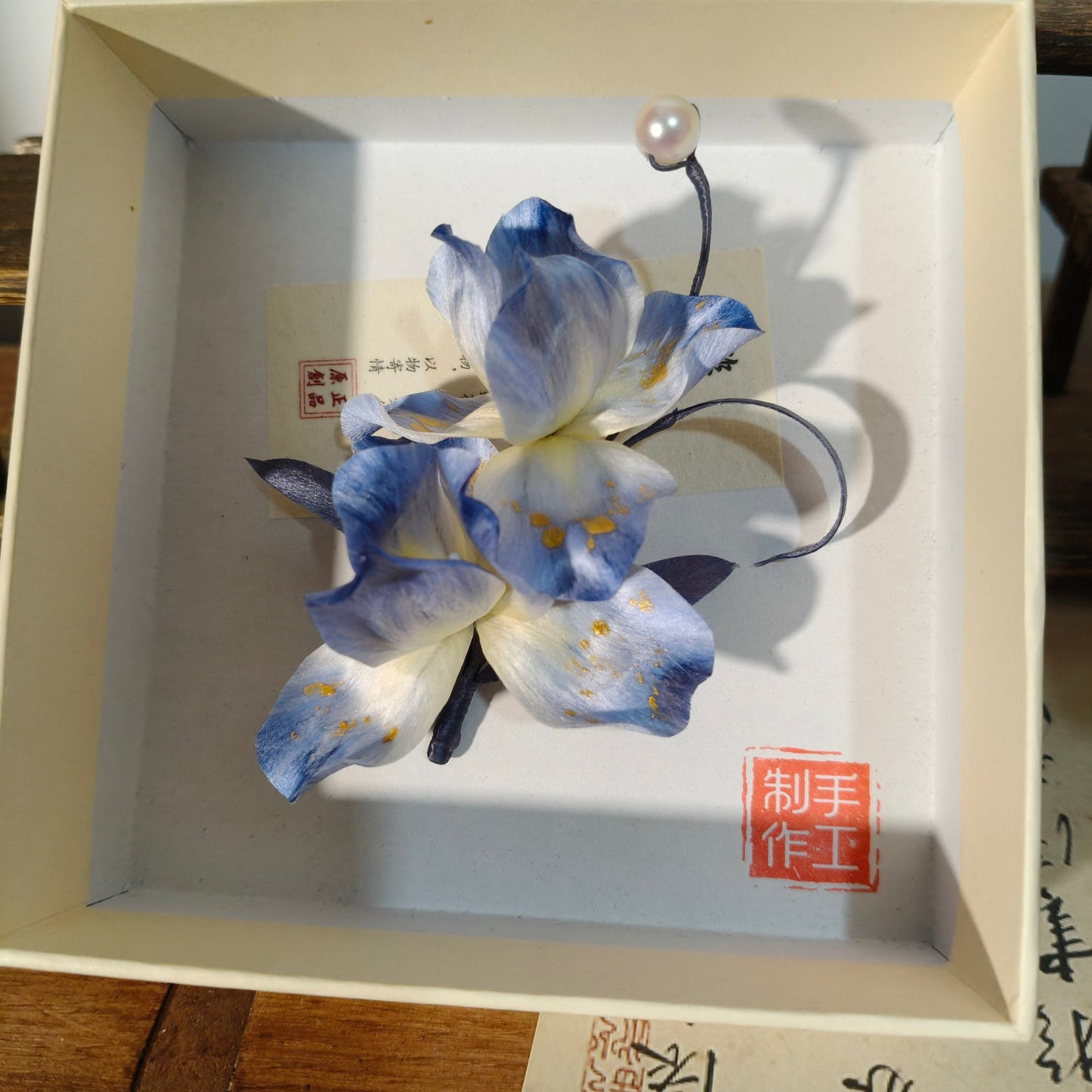 Close-up of blue iris Ronghua flowers in protective box