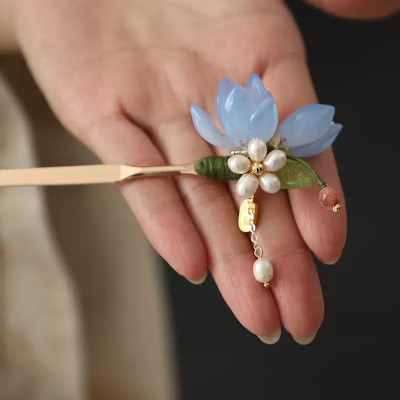Close-up of the blue magnolia hairpin and bead accents