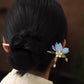 Blue magnolia hair stick worn in an updo