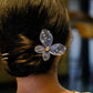 Blue mesh butterfly hairpin detail with gold-tone center