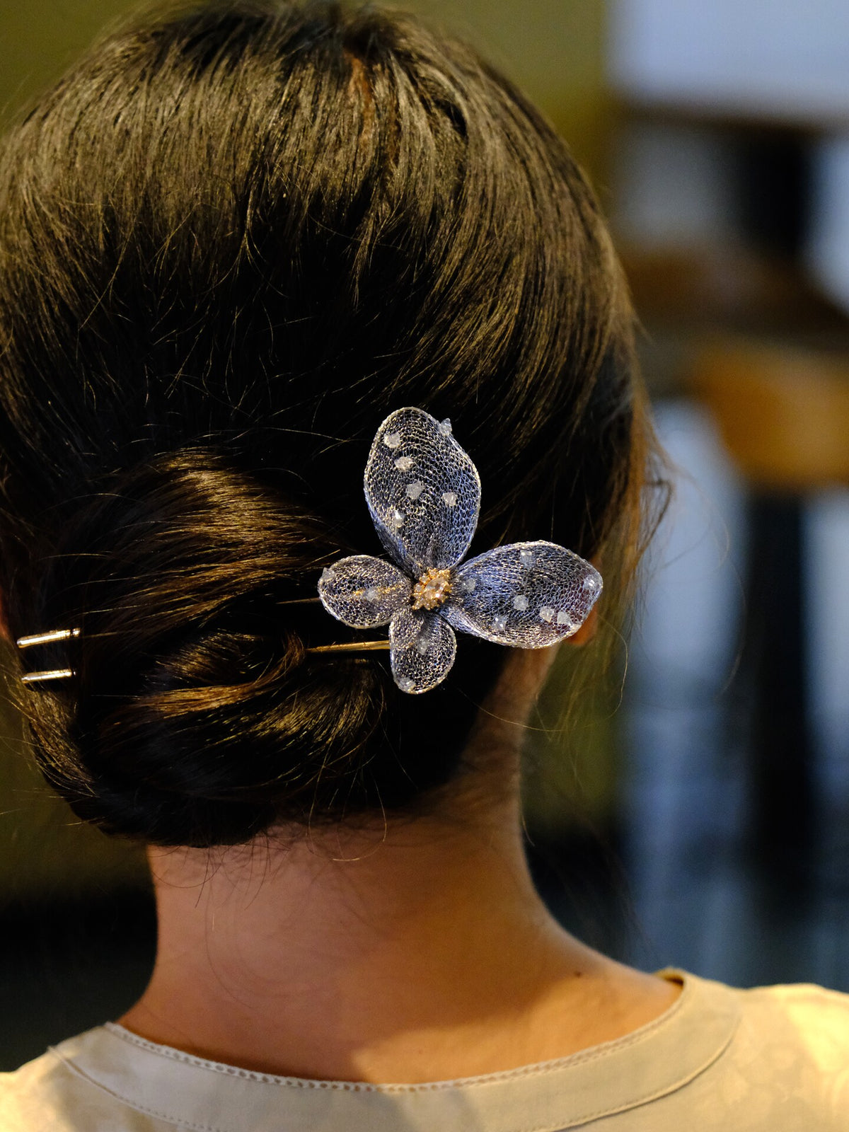Blue mesh butterfly hairpin detail with gold-tone center