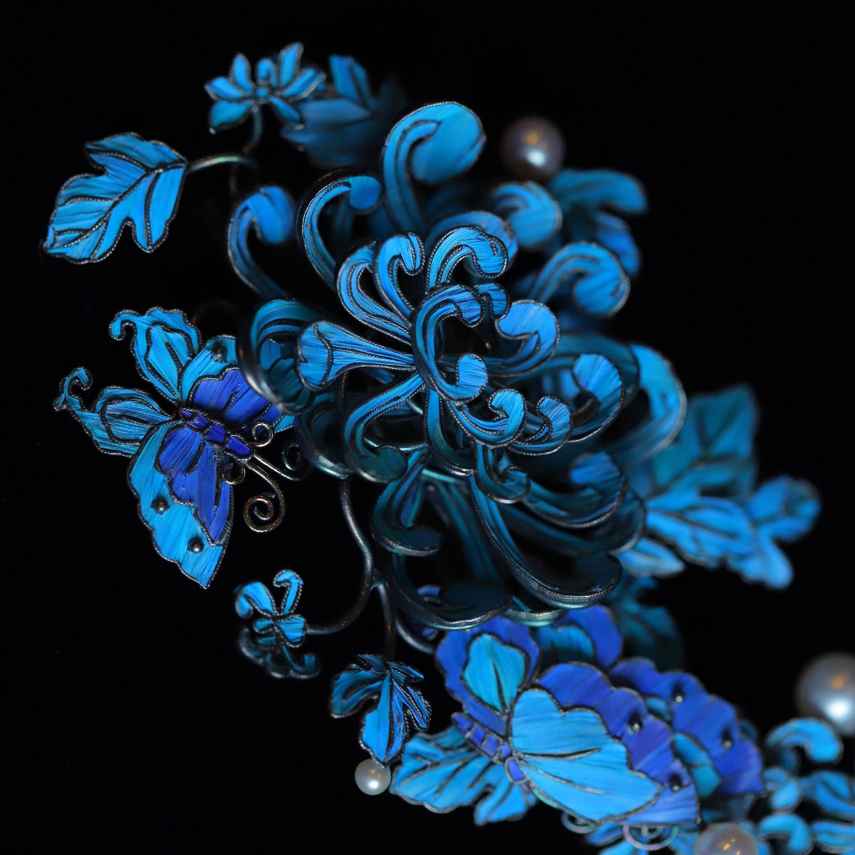 Close-up of the layered blue peony and butterfly motifs