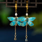 Pair of blue butterfly drop earrings with clip-on fastenings