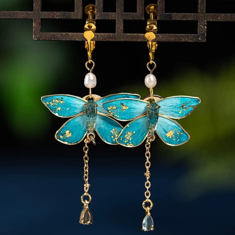 Pair of blue butterfly drop earrings with clip-on fastenings