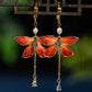 Pair of red butterfly drop earrings with clip-on fastenings