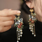 Colorful butterfly tassel earrings shown worn