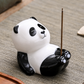 Ceramic panda incense holder with raised feet and a vertical incense stick
