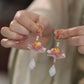 Close view of lotus drop earrings worn