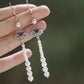 Pair of blue and red cloud motif drop earrings with white bead strands