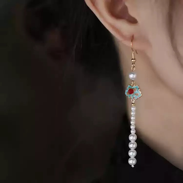 Turquoise and white bead tassel earring worn, side view