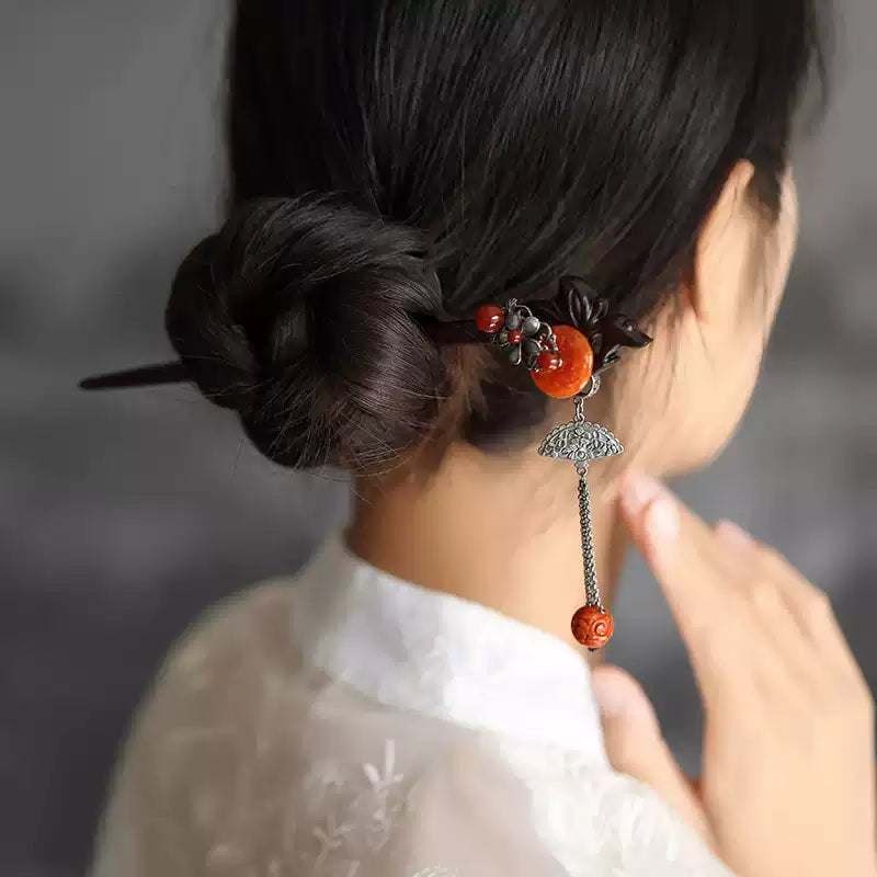 Red sandalwood hairpin styled in a low bun